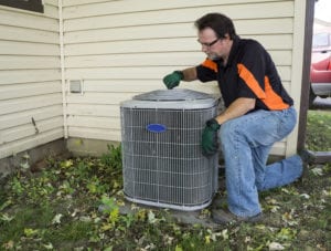 a/c unit being looked over by repair man